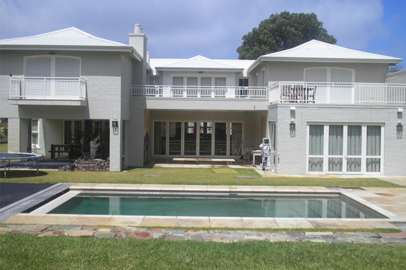 Grey mansion with pool, exterior painting completed